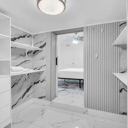 Spacious walk-in closet with built-in shelving for easy organization.