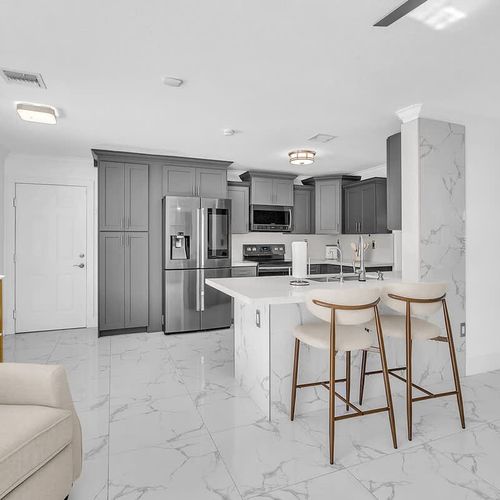 Open-concept kitchen with bar seating and seamless flow into the living area, ideal for entertaining.