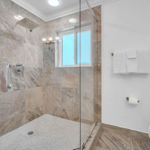 Spacious walk-in shower with elegant tilework and natural light for a spa-like feel.