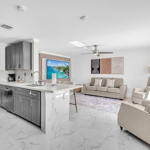Modern open-plan living room and kitchen with stylish finishes, ample seating, and a welcoming layout for gatherings.