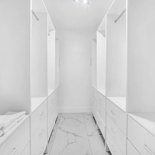 Large, custom walk-in closet with built-in storage and plenty of space to unpack and stay organized.