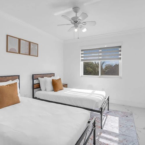 Double twin bedroom | Light-filled room with two twin beds—perfect for friends or kids—featuring clean decor and a relaxing vibe.