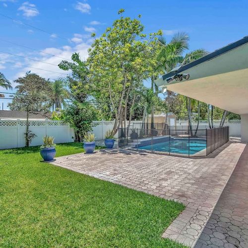 Enjoy the best of South Florida outdoor living in this spacious backyard oasis featuring a private pool, tropical landscaping, and a fully fenced setting designed for relaxation and privacy.