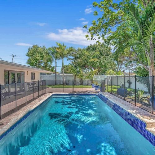 Escape to your own private tropical retreat with a fully fenced backyard, sparkling pool, swaying palm trees, and plenty of space to relax under the Miami sun.