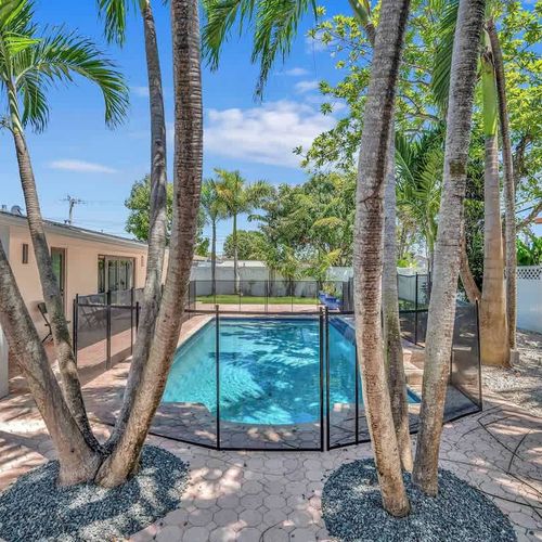 Soak up the Miami sunshine from this beautifully landscaped backyard complete with a refreshing private pool, spacious patio area, and lush tropical surroundings.