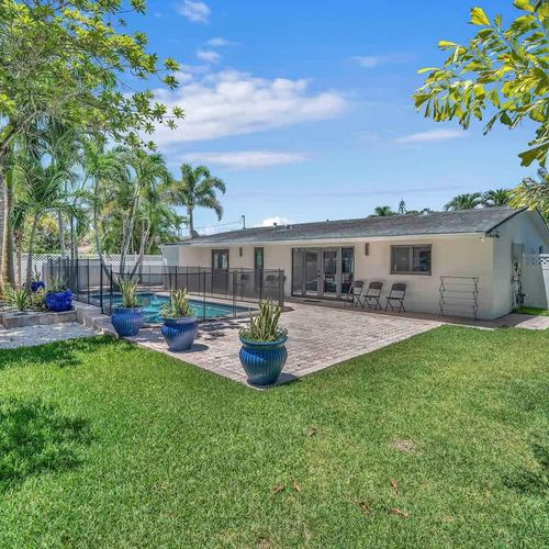 Enjoy the best of South Florida outdoor living in this spacious backyard oasis featuring a private pool, tropical landscaping, and a fully fenced setting designed for relaxation and privacy.