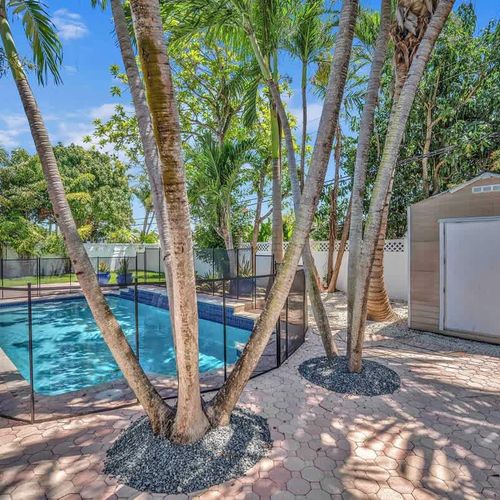 Escape to your own private tropical retreat with a fully fenced backyard, sparkling pool, swaying palm trees, and plenty of space to relax under the Miami sun.