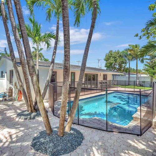 Soak up the Miami sunshine from this beautifully landscaped backyard complete with a refreshing private pool, spacious patio area, and lush tropical surroundings.
