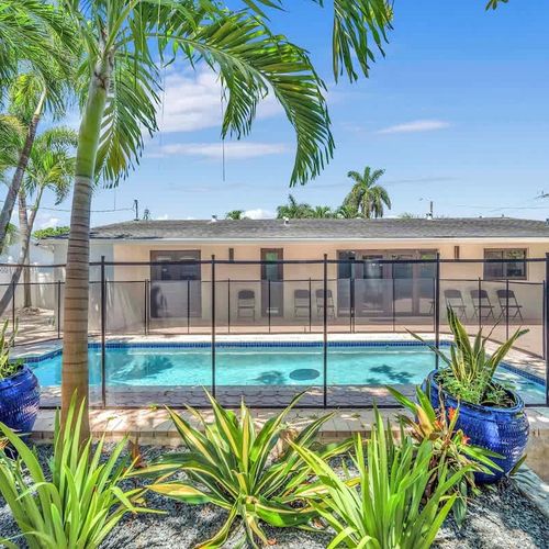 Soak up the Miami sunshine from this beautifully landscaped backyard complete with a refreshing private pool, spacious patio area, and lush tropical surroundings.