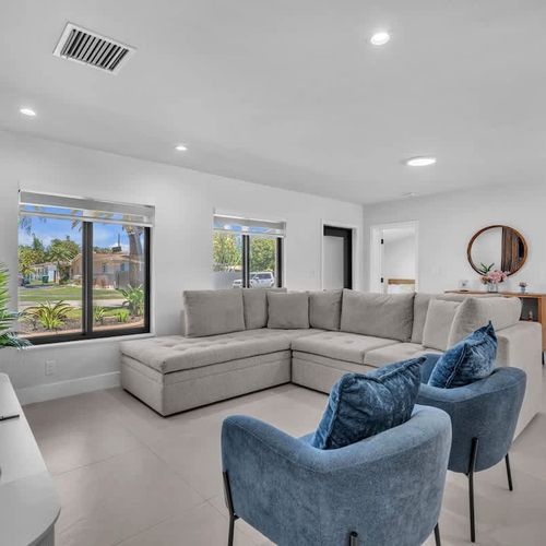 Clean modern interiors meet warm tropical touches in this airy living and dining area, complete with comfortable seating, sleek finishes, and a bright welcoming atmosphere.