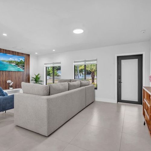 Clean modern interiors meet warm tropical touches in this airy living and dining area, complete with comfortable seating, sleek finishes, and a bright welcoming atmosphere.