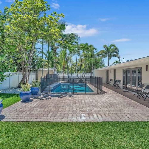 Escape to your own private tropical retreat with a fully fenced backyard, sparkling pool, swaying palm trees, and plenty of space to relax under the Miami sun.