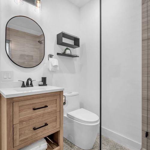 Generously sized bathroom with a walk-in shower—fully cleaned and stocked with fresh towels, a hairdryer, and basic bath essentials.