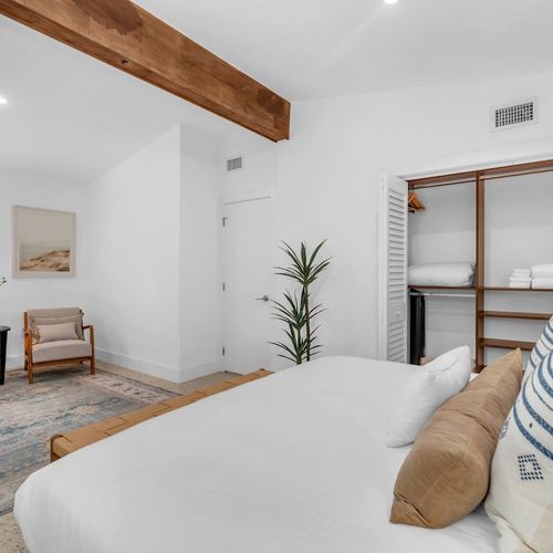 Spacious primary suite featuring a comfy King bed with plush bedding, and generous closet space.