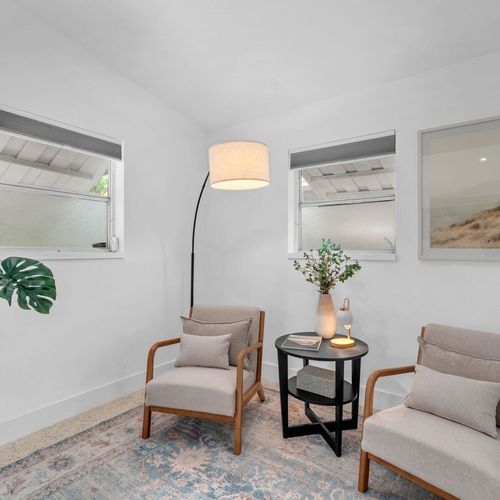 Perfect spot to get ready or unwind, featuring an arched full-length mirror and a cozy private lounge space.