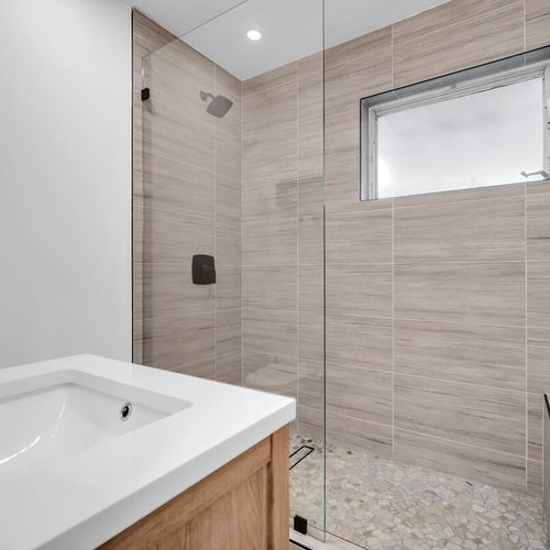 Generously sized bathroom with a walk-in shower—fully cleaned and stocked with fresh towels, a hairdryer, and basic bath essentials.