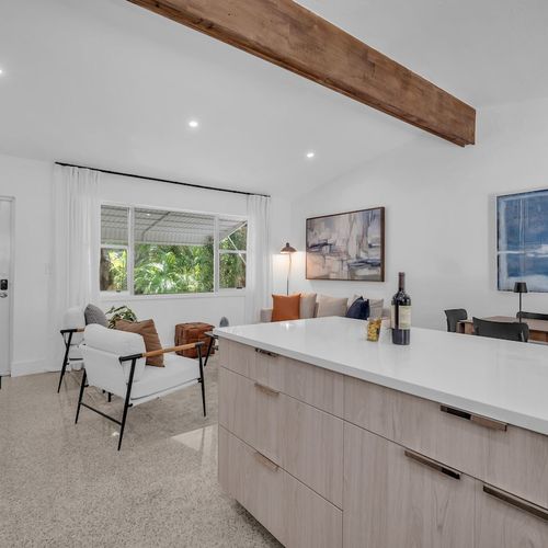 Stream your favorite shows on the large Smart TV in a stylish, light-filled living space surrounded by natural greenery.