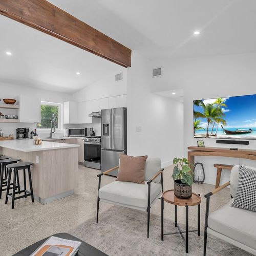 Bright, open-concept living and dining flowing seamlessly out to the private tropical garden.
