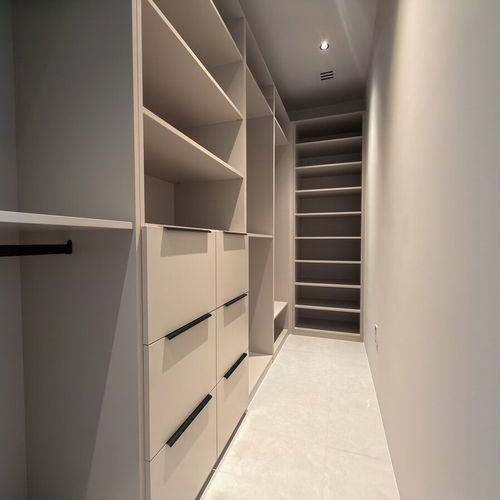 custom walk-in closet, built-in shelving, wardrobe organization, bedroom storage solutions.