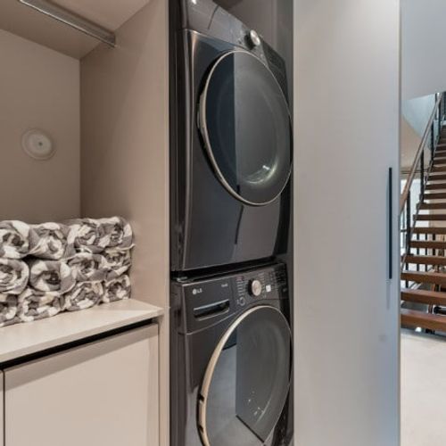 Enjoy the ultimate convenience of an in-unit laundry area during your stay. Tucked away seamlessly behind a sliding door, this space features a premium stacked front-load washer and dryer.