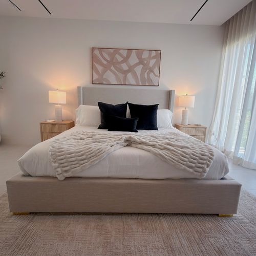 Experience ultimate relaxation in this luxurious, modern primary suite. Featuring a spacious king-sized bed, elegant neutral decor, and a dedicated vanity station, this bedroom is designed for comfort.