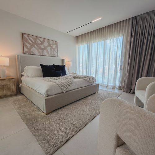 Welcome to your dream getaway oasis. Bedroom 1 offers a serene, sun-lit retreat complete with premium linens, plush accent pillows, and stylish modern furnishings