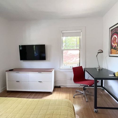 A simple work space to get things done. Eames Aluminum Group Chair for Herman Miller. Ample dresser and closet for your use.