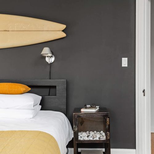 Nightstands on each side of bed. Industrial unfinished metal on casters. Tolomeo Wall Spot classic reading lamps by Artemide.