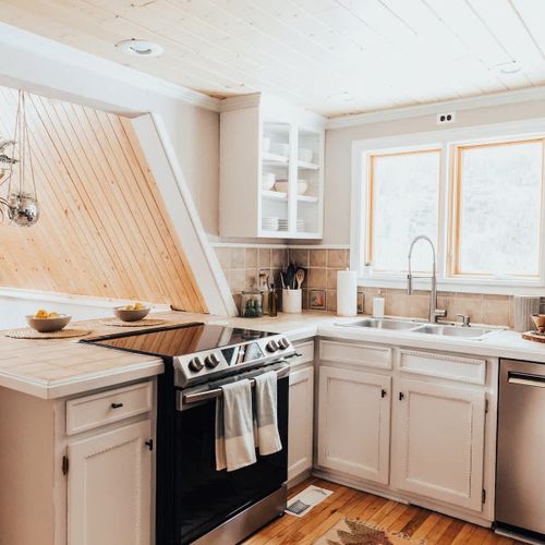 Well appointed kitchen with natural light and new appliances