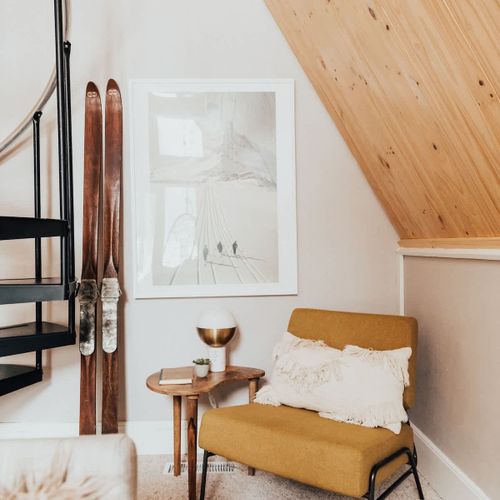 A cozy reading corner with vintage skis in the main living area
