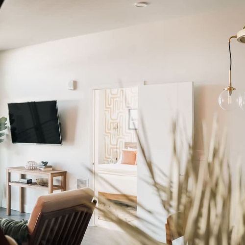 Reflection of living area and primary bedroom
