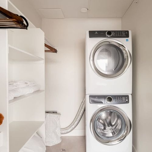 The walk in closet has a washer and dryer