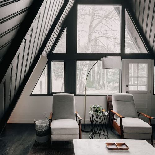 Living area looks out to forested area