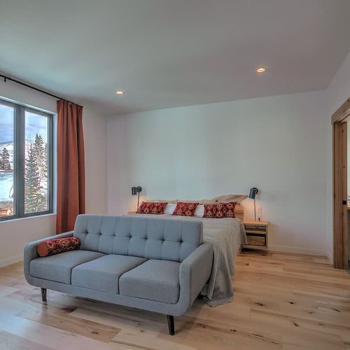 Primary bedroom with seating and king bed