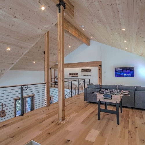 Upstairs living area with TV, seating, and a game table
