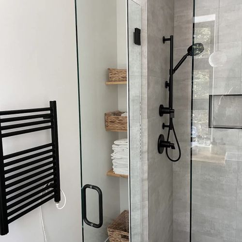 Full bathrooms with walk-in glass showers & towel warmers