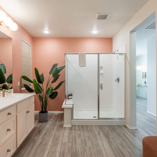 Walk-in glass shower in the primary bedroom's full ensuite bathroom
