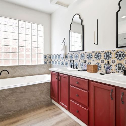 Primary bedroom's full ensuite bathroom with dual vanities