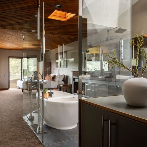 Large en suite bathroom in the primary bedroom with glass walls