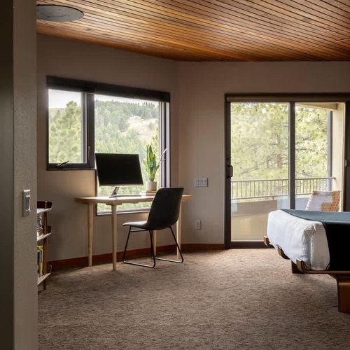 The primary bedroom has a desk, chair, and monitor