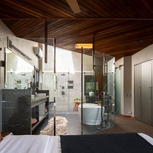Looking from the bed into the bathroom in the primary bedroom
