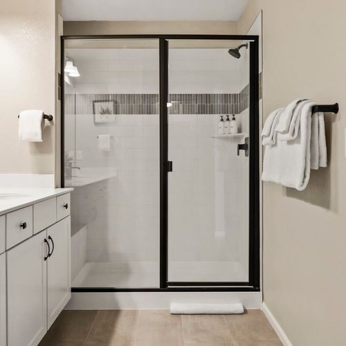 Primary bedroom's full private ensuite bathroom with a walk-in glass shower