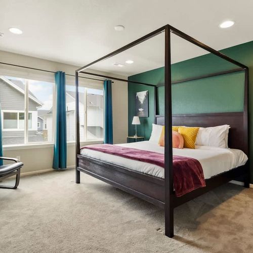 Primary bedroom with king bed and seating area