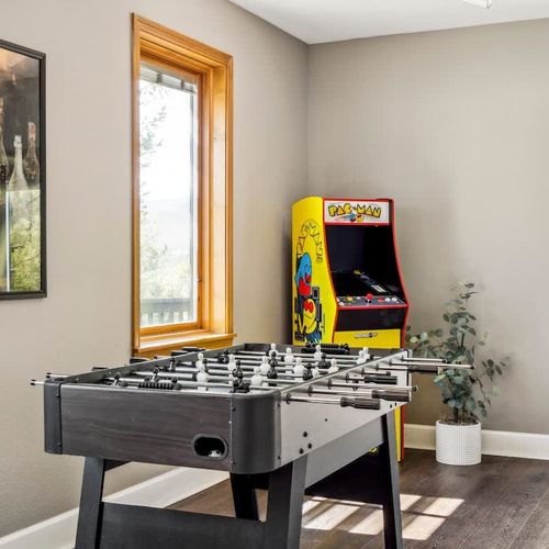 Game room with a foosball table and arcade machine