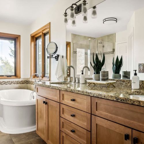 Primary bedroom's private full ensuite bathroom with dual vanities