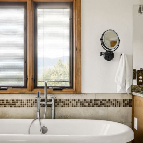 Primary bedroom's private full ensuite bathroom with soaking tub