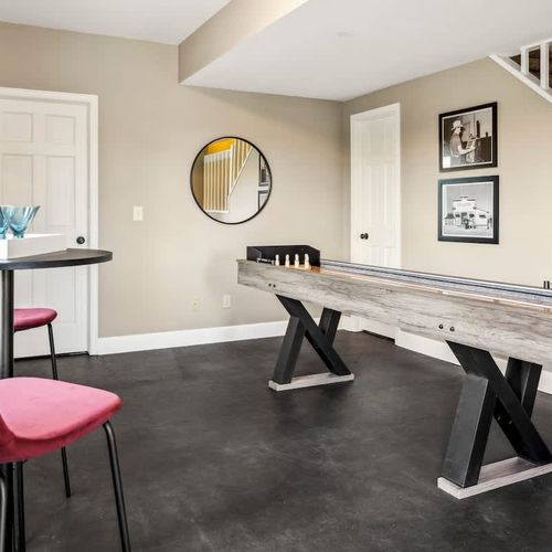 Game room with seating area tabletop shuffleboard