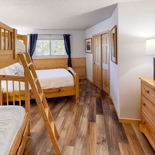 Bedroom 2 sleeps 5 and has a TV and en suite bathroom