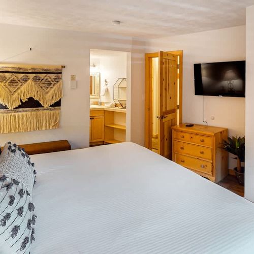 Bedroom 1 with king bed, TV, and en suite bathroom