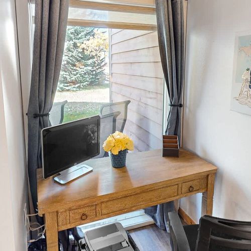 Workspace with desk, chair, monitor, and printer